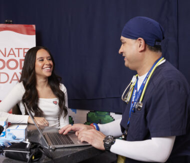 RIBC donor intake specialist taking information from a blood donor at RIBC donation center